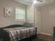 Neutral-toned bedroom with a daybed, window with blinds, and artwork on the wall at 2822 Tindall St, Indianapolis, IN 46203