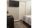 Cozy bedroom with a TV, rug, and view of a neatly organized closet at 2822 Tindall St, Indianapolis, IN 46203