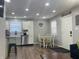 Open dining area featuring a table with four chairs, white cabinets and stainless steel appliances at 2822 Tindall St, Indianapolis, IN 46203