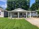 Charming home with a covered front porch, a swing, well-manicured lawn, and appealing curb appeal at 2822 Tindall St, Indianapolis, IN 46203