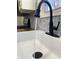 A close-up of the kitchen sink featuring a sleek black faucet and modern design at 2822 Tindall St, Indianapolis, IN 46203