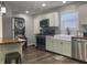 Updated kitchen boasts stainless appliances, farmhouse sink, butcher block counters, and convenient in-unit laundry at 2822 Tindall St, Indianapolis, IN 46203