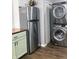This kitchen features a stainless refrigerator and stacked washer/dryer combo, maximizing space and efficiency at 2822 Tindall St, Indianapolis, IN 46203
