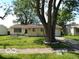 Cozy single-story home with a well-manicured lawn, mature tree, and an attached single car garage at 3213 S Cherokee Rd, Muncie, IN 47302