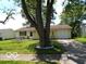 Charming single-story home with a well-maintained lawn, mature tree, and an attached single car garage at 3213 S Cherokee Rd, Muncie, IN 47302