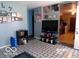 Functional living area with TV, shelving, and Gathering photos, providing a comfortable and personalized space at 3213 S Cherokee Rd, Muncie, IN 47302