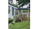 Side view of the home showcasing a porch and landscaping at 3216 Memorial N Dr, Elwood, IN 46036