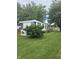 Back exterior view featuring partial porch with large lawn at 3216 Memorial N Dr, Elwood, IN 46036