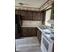 Picture of the kitchen featuring dark wood cabinets and laminate flooring at 3216 Memorial N Dr, Elwood, IN 46036