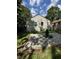 Backyard featuring home with siding, gravel space, air conditioning unit and green grass at 3711 Hillside Ave, Indianapolis, IN 46218