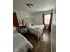 Comfortable bedroom features hardwood floors, two beds, warm curtains, and a giraffe wall decal at 3711 Hillside Ave, Indianapolis, IN 46218