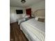 Inviting bedroom features hardwood floors, cozy beds, with overhead lighting and decor at 3711 Hillside Ave, Indianapolis, IN 46218