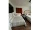 Cozy bedroom with two beds, hardwood floors, and a modern, mounted television at 3711 Hillside Ave, Indianapolis, IN 46218