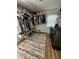 Large walk-in closet with ample hanging space, shelving, a decorative rug, and natural light from a window at 3711 Hillside Ave, Indianapolis, IN 46218