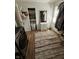 Well-organized closet with shelving, hanging rods, and a full-length mirror, next to a washer dryer combo at 3711 Hillside Ave, Indianapolis, IN 46218