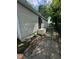 Home exterior with vinyl siding, black security door, and walkway to a shed, offering secure access at 3711 Hillside Ave, Indianapolis, IN 46218