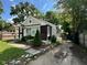 Charming home exterior features landscaping, unique windows, and a cozy, inviting entrance at 3711 Hillside Ave, Indianapolis, IN 46218