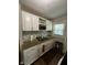Galley kitchen with white cabinetry, granite countertops, stainless steel appliances, and mosaic backsplash at 3711 Hillside Ave, Indianapolis, IN 46218