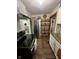 Bright kitchen features granite countertops, white cabinets, stainless steel appliances, and ample storage shelving at 3711 Hillside Ave, Indianapolis, IN 46218
