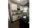 Well-lit kitchen features updated white cabinets, mosaic backsplash, granite counters, and stainless steel appliances at 3711 Hillside Ave, Indianapolis, IN 46218