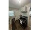 Modern kitchen with stainless steel appliances, white cabinets, stylish tile backsplash, and a window letting in plenty of light at 3711 Hillside Ave, Indianapolis, IN 46218