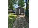 Exterior view of shed in backyard surrounded by trees, with ample storage and functional design at 3711 Hillside Ave, Indianapolis, IN 46218