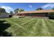 Spacious backyard with a brick home, well-maintained lawn, storage shed and large deck at 4675 N Riverside Dr, Columbus, IN 47203