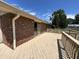 Backyard deck attached to a brick home with a sliding glass door overlooking a lush lawn at 4675 N Riverside Dr, Columbus, IN 47203