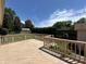 Back deck overlooking a large grassy yard with a shed and a well-maintained privacy hedge at 4675 N Riverside Dr, Columbus, IN 47203