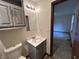 Bathroom featuring a sink and cabinet, toilet, mirror and light fixture, showing carpeted floor at 4675 N Riverside Dr, Columbus, IN 47203