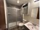 Bathroom featuring a shower with gray tiling, cabinet, toilet, and vanity with sink at 4675 N Riverside Dr, Columbus, IN 47203