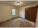 Bedroom featuring carpet, closet, and window at 4675 N Riverside Dr, Columbus, IN 47203
