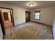 Bedroom with carpet, window, closet, and an open doorway revealing the hallway to the left at 4675 N Riverside Dr, Columbus, IN 47203