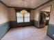 Dining room with classic wallpaper and an ornate chandelier near the kitchen at 4675 N Riverside Dr, Columbus, IN 47203
