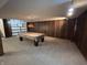 Finished basement featuring paneled walls and pool table with overhead lighting at 4675 N Riverside Dr, Columbus, IN 47203