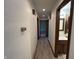 Hallway leading to a bathroom with wood-look flooring, revealing a bedroom at the end at 4675 N Riverside Dr, Columbus, IN 47203