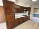 Bright kitchen with wood cabinets, stainless steel appliances, and tile flooring at 4675 N Riverside Dr, Columbus, IN 47203
