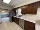 Stainless steel fridge and sink with window, surrounded by ample cabinetry at 4675 N Riverside Dr, Columbus, IN 47203