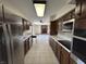 Long Galley kitchen, featuring stainless appliances and ample wood cabinetry at 4675 N Riverside Dr, Columbus, IN 47203