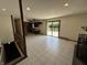 Bright living room with tile flooring, recessed lights, and a sliding door to the deck at 4675 N Riverside Dr, Columbus, IN 47203