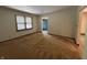 Bright living room with neutral carpet, fresh paint, and a window at 4675 N Riverside Dr, Columbus, IN 47203