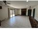 Large living room featuring tile flooring, a brick fireplace, and sliding door access to the deck at 4675 N Riverside Dr, Columbus, IN 47203