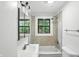 Bathroom with a shower, toilet, sink and a window at 4765 E 200 N, Anderson, IN 46012