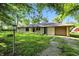 Well-kept ranch style home with attached garage, mature trees, and an expansive front lawn at 4765 E 200 N, Anderson, IN 46012