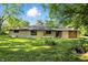 Charming ranch home features a well-manicured lawn, attached garage, and mature trees at 4765 E 200 N, Anderson, IN 46012