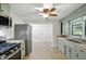 A lovely kitchen with gas range oven, stainless refrigerator and open door to other areas at 4765 E 200 N, Anderson, IN 46012