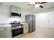 Efficient kitchen with stainless steel appliances, natural wood countertops, and green cabinets at 4765 E 200 N, Anderson, IN 46012