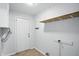 Well-lit laundry room has a shelf, hanging rack, and connections for laundry appliances at 4765 E 200 N, Anderson, IN 46012