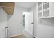 A bright laundry room with utility connections and a view into an adjacent room at 4765 E 200 N, Anderson, IN 46012