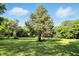 Expansive backyard featuring lush green lawn and mature trees, perfect for outdoor activities at 4765 E 200 N, Anderson, IN 46012